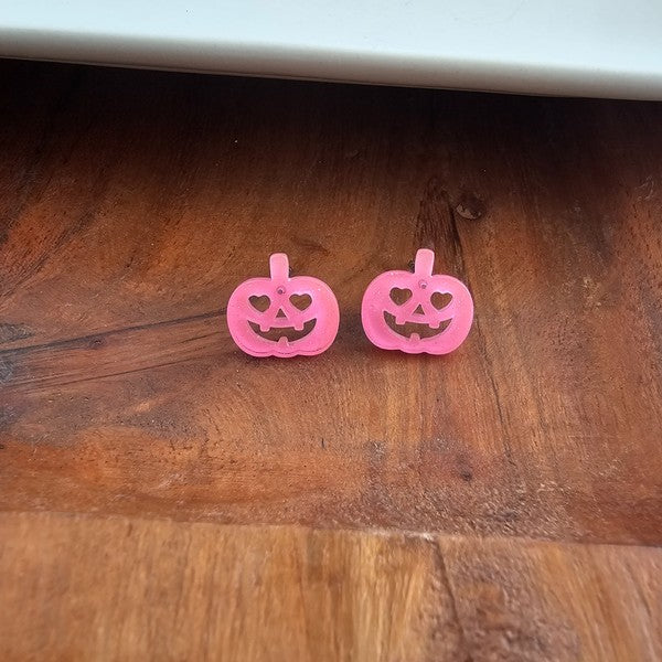 Shop Jack O Lantern Pumpkin Studs - Pink Glitter-Pink glitter jack o’ lantern earrings with hypoallergenic posts. Lightweight, festive, and fun—add a flirty twist to your Halloween or fall accessory lineup.-available at Reef Love online boho-chic boutique
