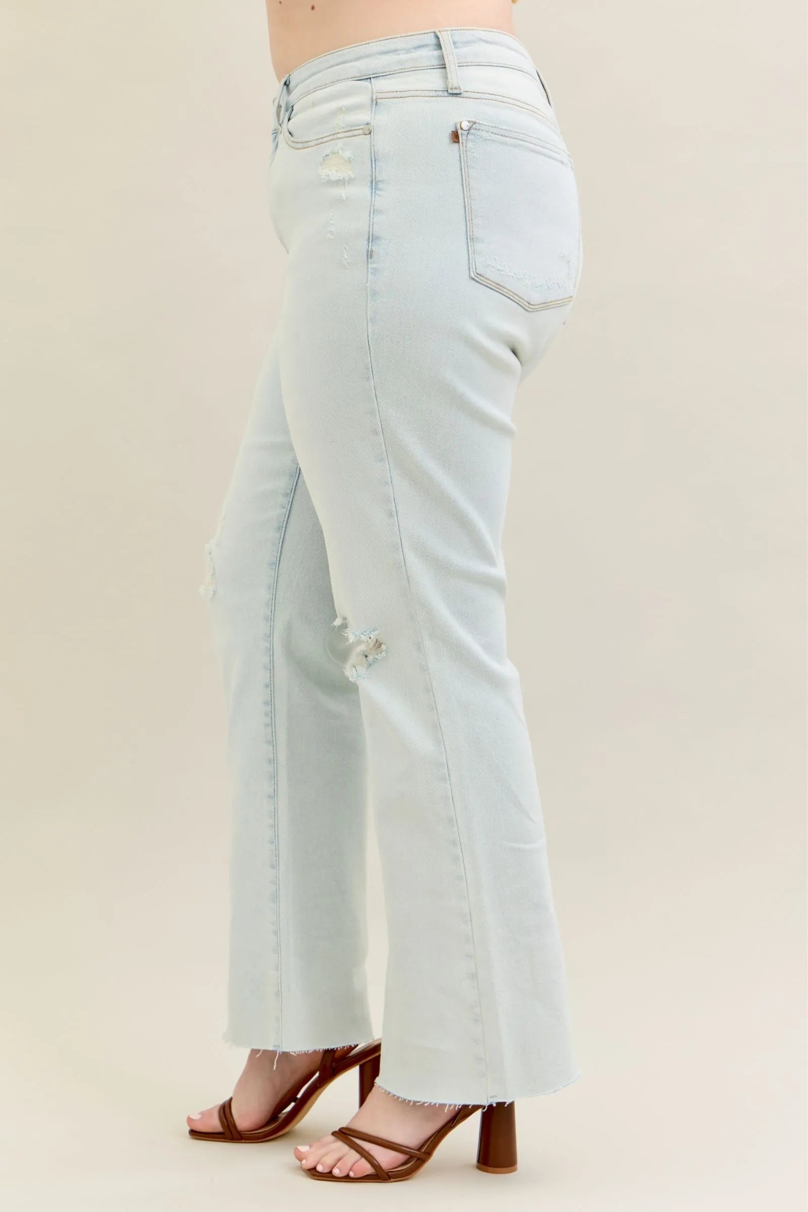 Person wearing Judy Blue Destroy & Fray Hem Straight Leg Light Wash Jeans by Reef Love