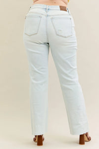 Person wearing Judy Blue Destroy & Fray Hem Straight Leg Light Wash Jeans by Reef Love