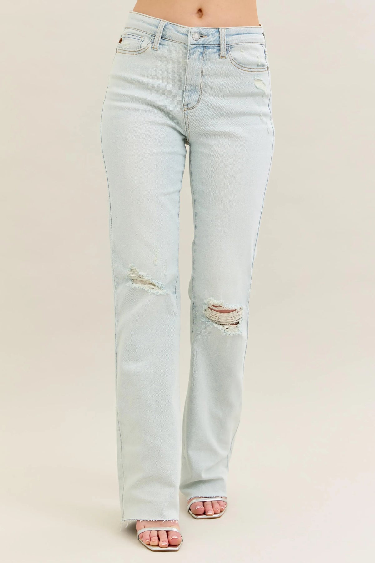 Person wearing Judy Blue Destroy & Fray Hem Straight Leg Light Wash Jeans by Reef Love