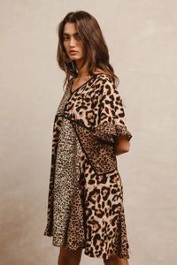 Leopard Print Mix and Match Mini Dress-Leopard Print Mix & Match Mini Dress, featuring a mix of leopard prints in rich, earthy tones. Designed with a V-neckline, flutter sleeves, and an empire waist.-Reef Love Boho-Chic Boutique