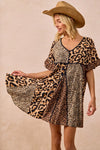 Leopard Print Mix and Match Mini Dress-Leopard Print Mix & Match Mini Dress, featuring a mix of leopard prints in rich, earthy tones. Designed with a V-neckline, flutter sleeves, and an empire waist.-Reef Love Boho-Chic Boutique