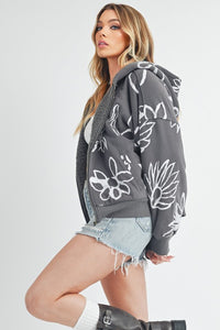 Shop Oita Floral Zip Front Hoodie-Cozy meets cool in the Oita Floral Zip-Up Hoodie - sherpa-lined warmth, bold floral print, and a bomber fit make this your new cold-weather go-to.-available at Reef Love online boho-chic boutique
