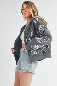 Shop Oita Floral Zip Front Hoodie-Cozy meets cool in the Oita Floral Zip-Up Hoodie - sherpa-lined warmth, bold floral print, and a bomber fit make this your new cold-weather go-to.-available at Reef Love online boho-chic boutique