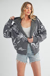 Shop Oita Floral Zip Front Hoodie-Cozy meets cool in the Oita Floral Zip-Up Hoodie - sherpa-lined warmth, bold floral print, and a bomber fit make this your new cold-weather go-to.-available at Reef Love online boho-chic boutique