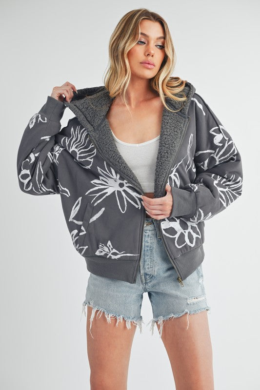 Shop Oita Floral Zip Front Hoodie-Cozy meets cool in the Oita Floral Zip-Up Hoodie - sherpa-lined warmth, bold floral print, and a bomber fit make this your new cold-weather go-to.-available at Reef Love online boho-chic boutique