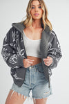 Shop Oita Floral Zip Front Hoodie-Cozy meets cool in the Oita Floral Zip-Up Hoodie - sherpa-lined warmth, bold floral print, and a bomber fit make this your new cold-weather go-to.-available at Reef Love online boho-chic boutique