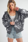 Shop Oita Floral Zip Front Hoodie-Cozy meets cool in the Oita Floral Zip-Up Hoodie - sherpa-lined warmth, bold floral print, and a bomber fit make this your new cold-weather go-to.-available at Reef Love online boho-chic boutique
