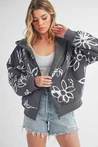 Shop Oita Floral Zip Front Hoodie-Cozy meets cool in the Oita Floral Zip-Up Hoodie - sherpa-lined warmth, bold floral print, and a bomber fit make this your new cold-weather go-to.-available at Reef Love online boho-chic boutique