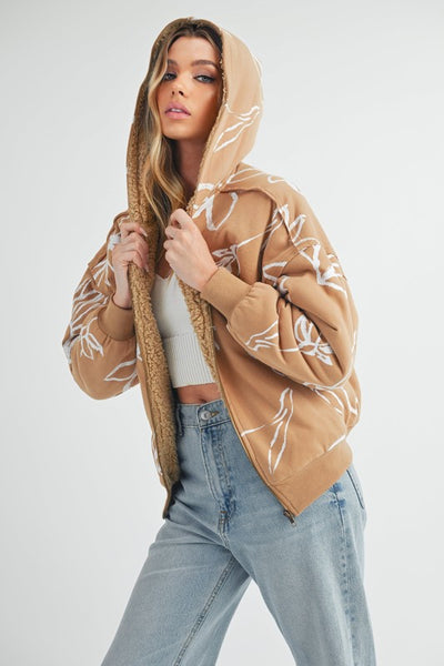 Shop Oita Floral Zip Front Hoodie-Cozy meets cool in the Oita Floral Zip-Up Hoodie - sherpa-lined warmth, bold floral print, and a bomber fit make this your new cold-weather go-to.-available at Reef Love online boho-chic boutique