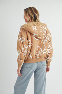 Shop Oita Floral Zip Front Hoodie-Cozy meets cool in the Oita Floral Zip-Up Hoodie - sherpa-lined warmth, bold floral print, and a bomber fit make this your new cold-weather go-to.-available at Reef Love online boho-chic boutique