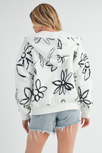 Shop Oita Floral Zip Front Hoodie-Cozy meets cool in the Oita Floral Zip-Up Hoodie - sherpa-lined warmth, bold floral print, and a bomber fit make this your new cold-weather go-to.-available at Reef Love online boho-chic boutique