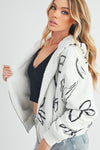 Shop Oita Floral Zip Front Hoodie-Cozy meets cool in the Oita Floral Zip-Up Hoodie - sherpa-lined warmth, bold floral print, and a bomber fit make this your new cold-weather go-to.-available at Reef Love online boho-chic boutique