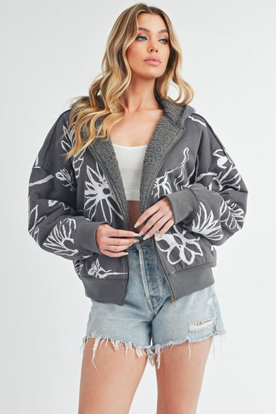 Shop Oita Floral Zip Front Hoodie-Cozy meets cool in the Oita Floral Zip-Up Hoodie - sherpa-lined warmth, bold floral print, and a bomber fit make this your new cold-weather go-to.-available at Reef Love online boho-chic boutique