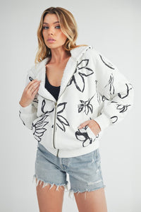 Shop Oita Floral Zip Front Hoodie-Cozy meets cool in the Oita Floral Zip-Up Hoodie - sherpa-lined warmth, bold floral print, and a bomber fit make this your new cold-weather go-to.-available at Reef Love online boho-chic boutique