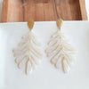 Shop Palm Earrings - Seashell Cream-Seashell cream palm leaf earrings with gold accents. Lightweight, tropical-inspired statement style—perfect for vacations, summer events, or everyday chic.-available at Reef Love online boho-chic boutique