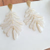 Shop Palm Earrings - Seashell Cream-Seashell cream palm leaf earrings with gold accents. Lightweight, tropical-inspired statement style—perfect for vacations, summer events, or everyday chic.-available at Reef Love online boho-chic boutique