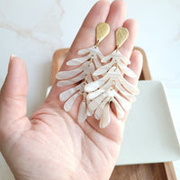 Shop Palm Earrings - Seashell Cream-Seashell cream palm leaf earrings with gold accents. Lightweight, tropical-inspired statement style—perfect for vacations, summer events, or everyday chic.-available at Reef Love online boho-chic boutique