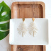 Shop Palm Earrings - Seashell Cream-Seashell cream palm leaf earrings with gold accents. Lightweight, tropical-inspired statement style—perfect for vacations, summer events, or everyday chic.-available at Reef Love online boho-chic boutique