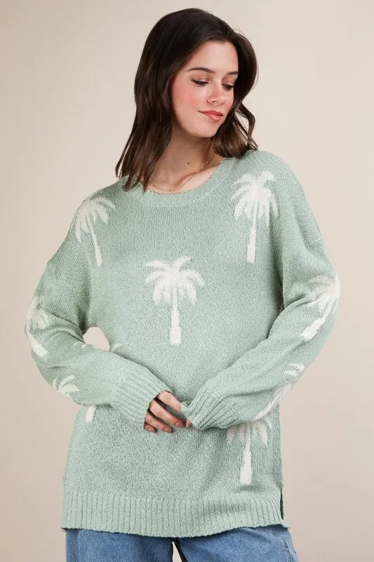 Women's Sage color palm tree graphic oversized knit sweater is a cozy and stylish sweater. The oversized fit adds a relaxed and comfortable vibe to the sweater - sold by Reef Love