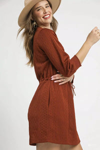 Rust Drawstring Cable Knit Mini Dress-Rust Drawstring Cable Knit Mini Dress. This cable knit mini dress features a drawstring waist and convenient pockets for a cozy and practical look. 