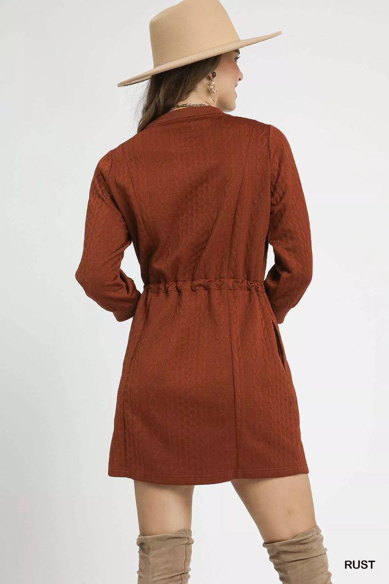 Rust Drawstring Cable Knit Mini Dress-Rust Drawstring Cable Knit Mini Dress. This cable knit mini dress features a drawstring waist and convenient pockets for a cozy and practical look. 