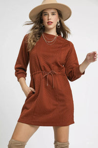 Rust Drawstring Cable Knit Mini Dress-Rust Drawstring Cable Knit Mini Dress. This cable knit mini dress features a drawstring waist and convenient pockets for a cozy and practical look. 