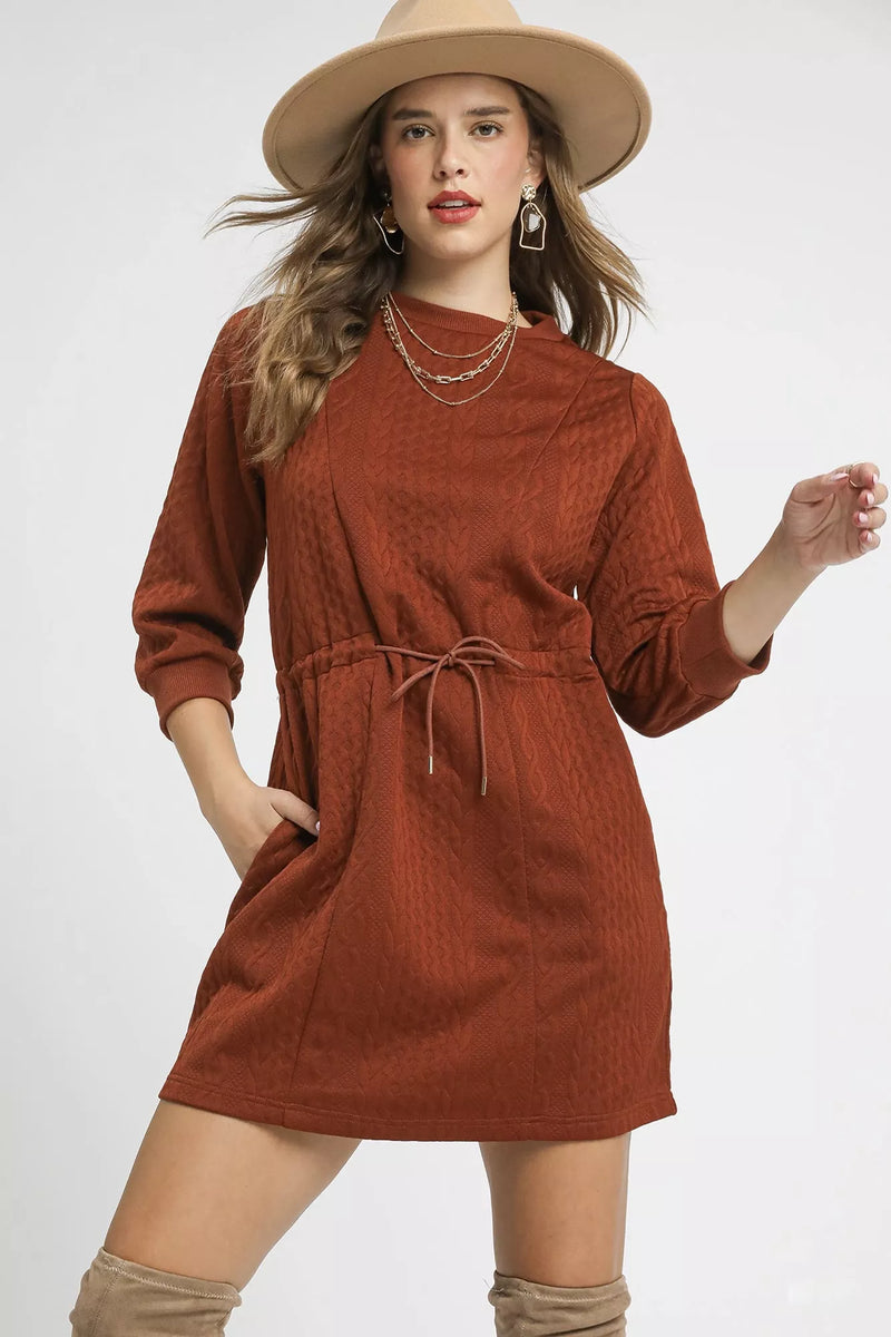 Rust Drawstring Cable Knit Mini Dress-Rust Drawstring Cable Knit Mini Dress. This cable knit mini dress features a drawstring waist and convenient pockets for a cozy and practical look. 