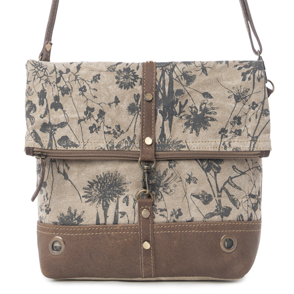 Floral patterned bag with brown accents on a white background