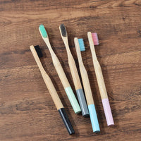 Woman wearing 5 Pack Adult Bamboo Toothbrush Medium Bristles Eco Friendly-5-pack bamboo toothbrush set with biodegradable handles & medium BPA-free bristles. Eco-friendly, vegan, plastic-free & individually packaged.