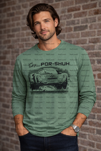 Man wearing a green long-sleeve shirt with a VINTAGE PORSCHE 396 car graphic and text against a brick wall.