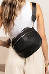 Oversized Leather Crescent Sling. Vegan leather crossbody sling, multiple zip pockets, adjustable strap, and gold hardware.