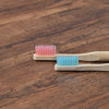 Woman wearing 5 Pack Adult Bamboo Toothbrush Medium Bristles Eco Friendly-5-pack bamboo toothbrush set with biodegradable handles & medium BPA-free bristles. Eco-friendly, vegan, plastic-free & individually packaged.