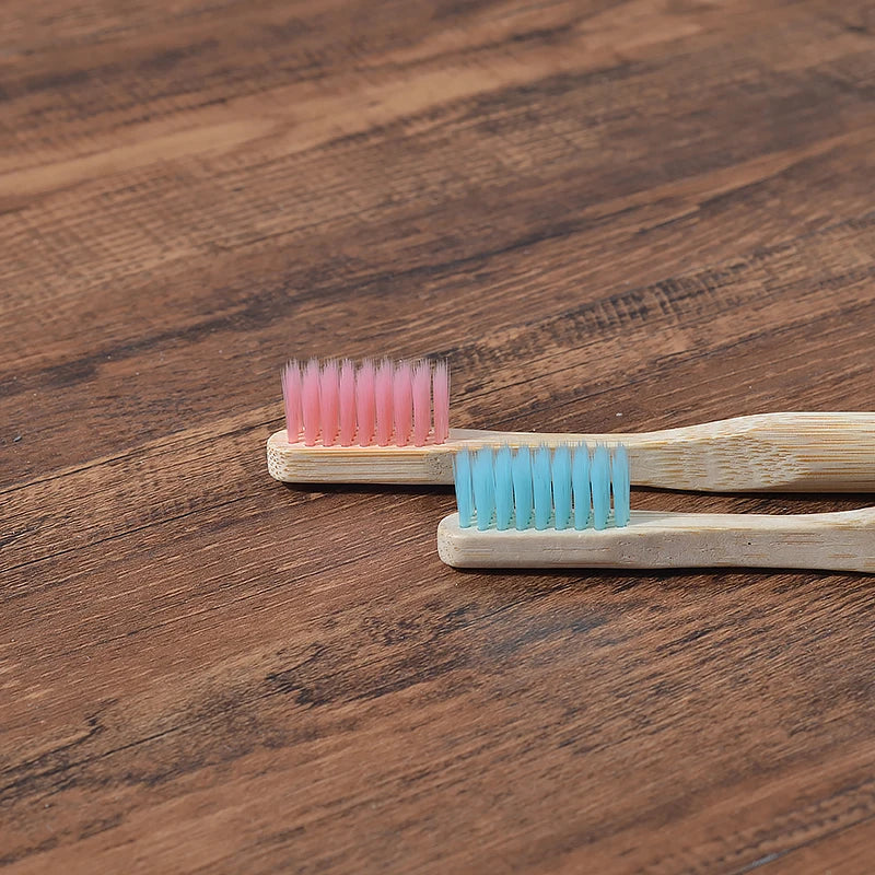 Woman wearing 5 Pack Adult Bamboo Toothbrush Medium Bristles Eco Friendly-5-pack bamboo toothbrush set with biodegradable handles & medium BPA-free bristles. Eco-friendly, vegan, plastic-free & individually packaged.