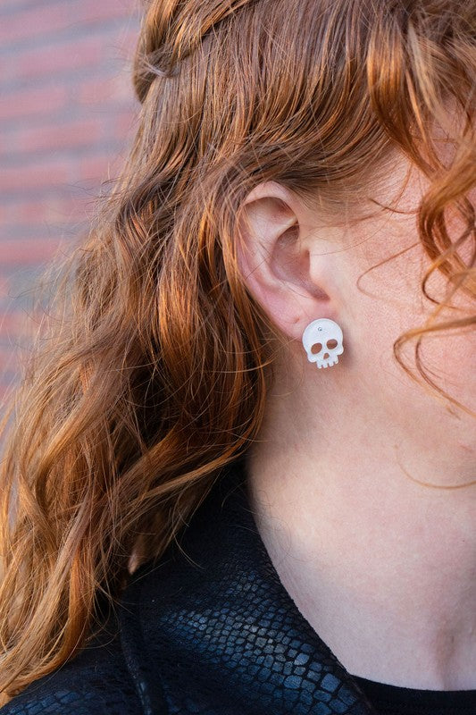 Shop Skull Studs - White Glitter-White glitter skull stud earrings made from lightweight acrylic with hypoallergenic posts. A sparkling, spooky touch for Halloween or fun everyday edgy style.-available at Reef Love online boho-chic boutique