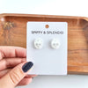 Shop Skull Studs - White Glitter-White glitter skull stud earrings made from lightweight acrylic with hypoallergenic posts. A sparkling, spooky touch for Halloween or fun everyday edgy style.-available at Reef Love online boho-chic boutique