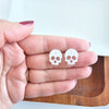 Shop Skull Studs - White Glitter-White glitter skull stud earrings made from lightweight acrylic with hypoallergenic posts. A sparkling, spooky touch for Halloween or fun everyday edgy style.-available at Reef Love online boho-chic boutique