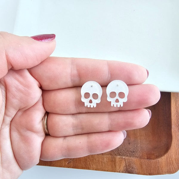 Shop Skull Studs - White Glitter-White glitter skull stud earrings made from lightweight acrylic with hypoallergenic posts. A sparkling, spooky touch for Halloween or fun everyday edgy style.-available at Reef Love online boho-chic boutique