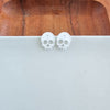 Shop Skull Studs - White Glitter-White glitter skull stud earrings made from lightweight acrylic with hypoallergenic posts. A sparkling, spooky touch for Halloween or fun everyday edgy style.-available at Reef Love online boho-chic boutique