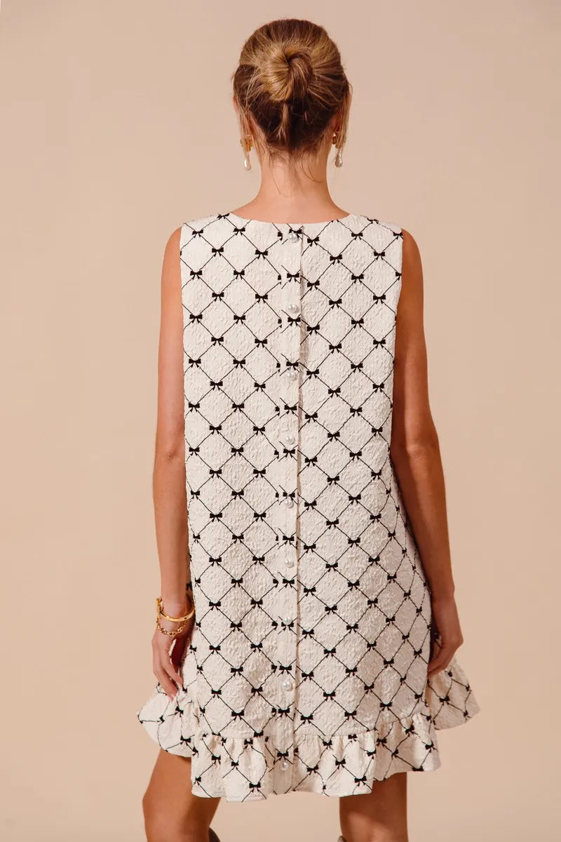 Texture Bow Printed Ruffle Mini Dress-Chic black & white bow print mini dress with a playful ruffle hem. Sleeveless & lightweight for effortless summer style, perfect for day or night outings.-Reef Love Boho-Chic Boutique