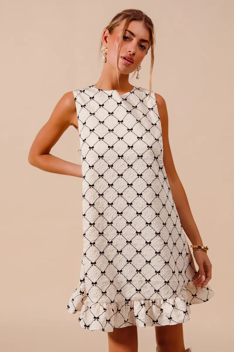Texture Bow Printed Ruffle Mini Dress-Chic black & white bow print mini dress with a playful ruffle hem. Sleeveless & lightweight for effortless summer style, perfect for day or night outings.-Reef Love Boho-Chic Boutique