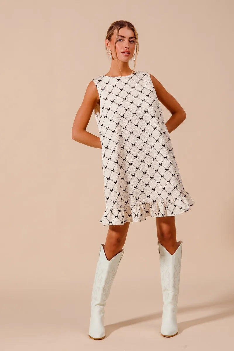 Texture Bow Printed Ruffle Mini Dress-Chic black & white bow print mini dress with a playful ruffle hem. Sleeveless & lightweight for effortless summer style, perfect for day or night outings.-Reef Love Boho-Chic Boutique