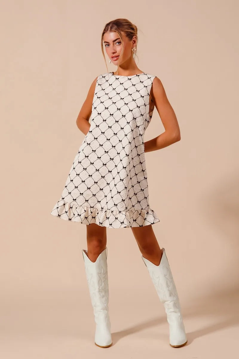 Texture Bow Printed Ruffle Mini Dress-Chic black & white bow print mini dress with a playful ruffle hem. Sleeveless & lightweight for effortless summer style, perfect for day or night outings.-Reef Love Boho-Chic Boutique