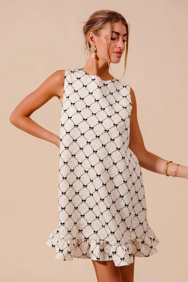 Texture Bow Printed Ruffle Mini Dress-Chic black & white bow print mini dress with a playful ruffle hem. Sleeveless & lightweight for effortless summer style, perfect for day or night outings.-Reef Love Boho-Chic Boutique