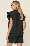 Women's Black Textured, stretchy, and comfy flounce sleeve top and drawstring shorts set. This set is perfect for a travel day, or out running around town, the set can also be dressed up with heels and accessories for versatility while on the go - Reef Love