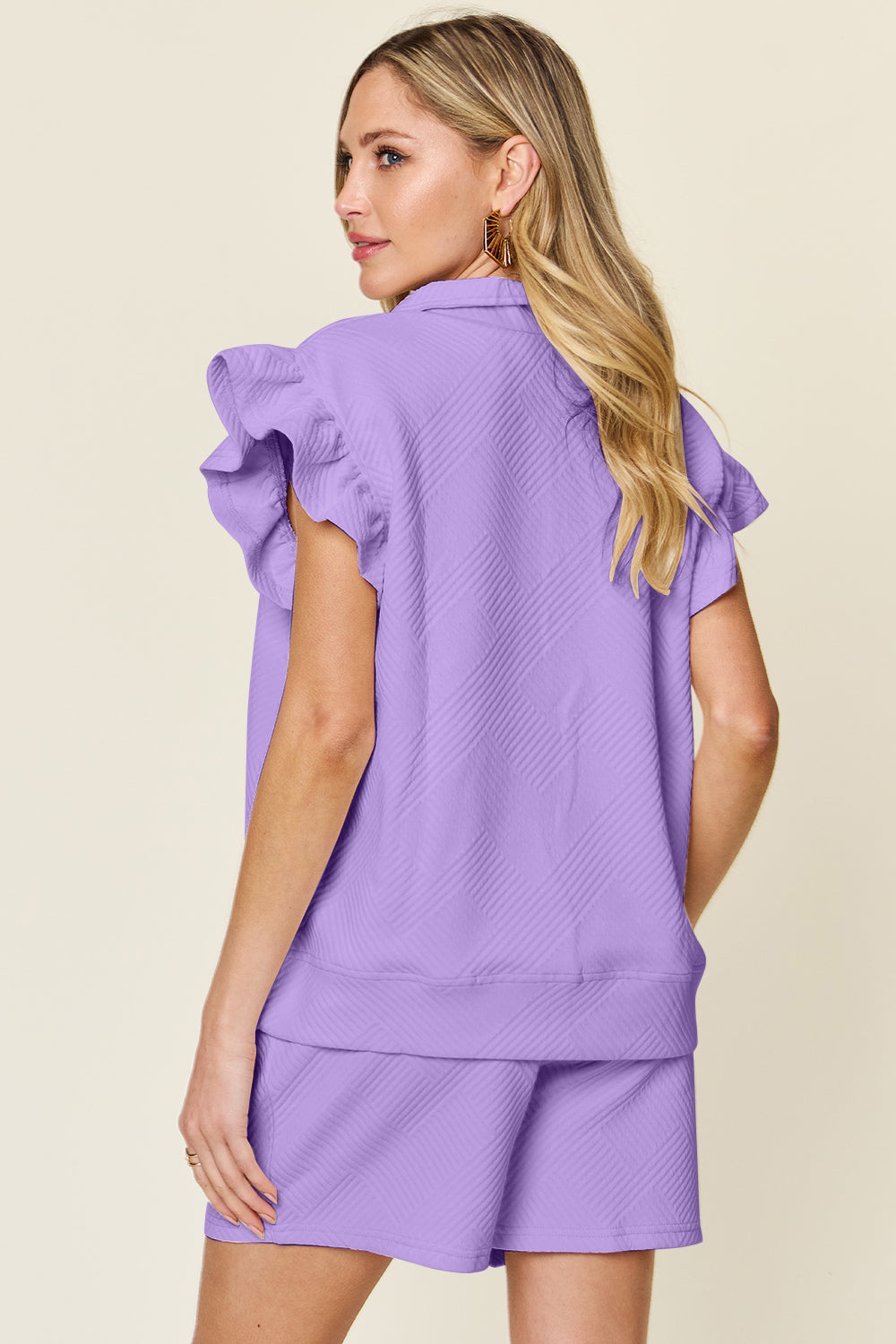 Women's purple Textured, stretchy, and comfy flounce sleeve top and drawstring shorts set. This set is perfect for a travel day, or out running around town, the set can also be dressed up with heels and accessories for versatility while on the go - Reef Love