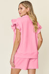 Women's pink Textured, stretchy, and comfy flounce sleeve top and drawstring shorts set. This set is perfect for a travel day, or out running around town, the set can also be dressed up with heels and accessories for versatility while on the go - Reef Love