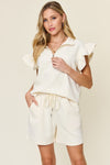 Women's Textured, stretchy, and comfy flounce sleeve top and drawstring shorts set. This set is perfect for a travel day, or out running around town, the set can also be dressed up with heels and accessories for versatility while on the go - Reef Love
