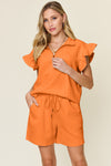 Women's orange Textured, stretchy, and comfy flounce sleeve top and drawstring shorts set. This set is perfect for a travel day, or out running around town, the set can also be dressed up with heels and accessories for versatility while on the go - Reef Love
