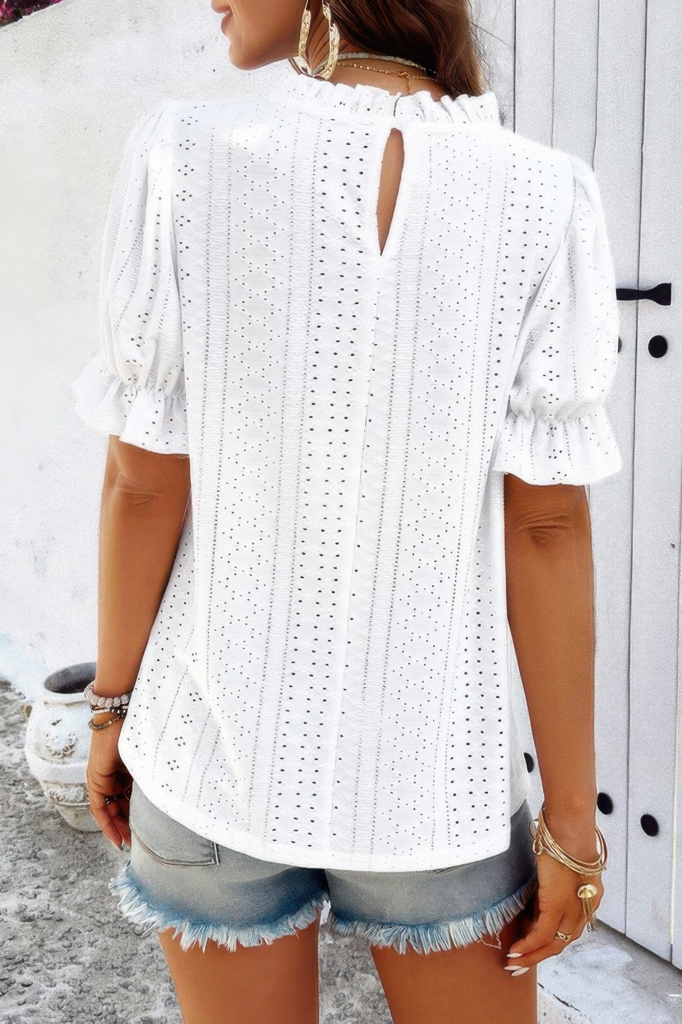 Woman wearing Embroidery Ruffle Sleeve Loose Fit Blouse-Add a touch of charm to your everyday look with this round neck embroidered shirt, featuring ruffle sleeves and a relaxed silhouette and intricate embroidery.
